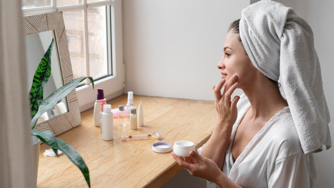 Woman applying face cream during a daily skin care routine at home